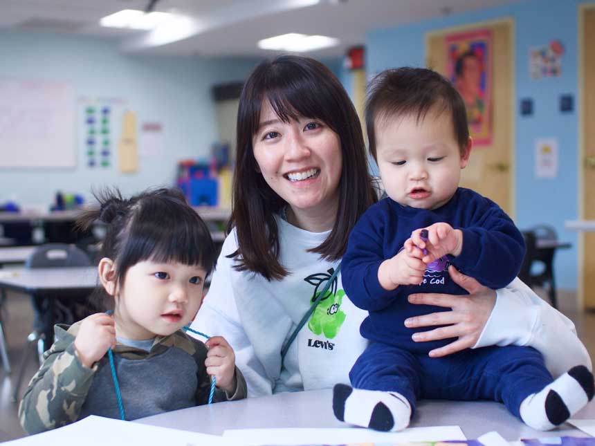 mom holding son and daughter
