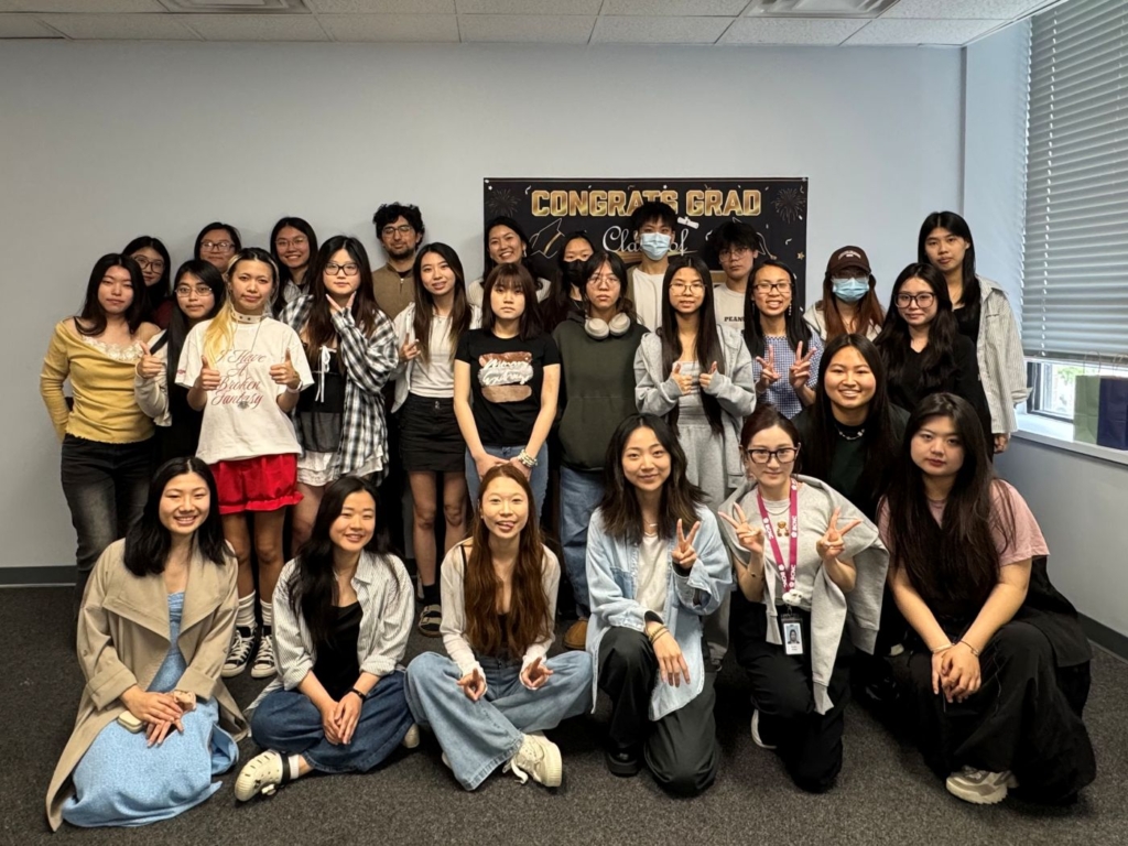 Twenty-seven young adults pose together for their 2025 class photo.